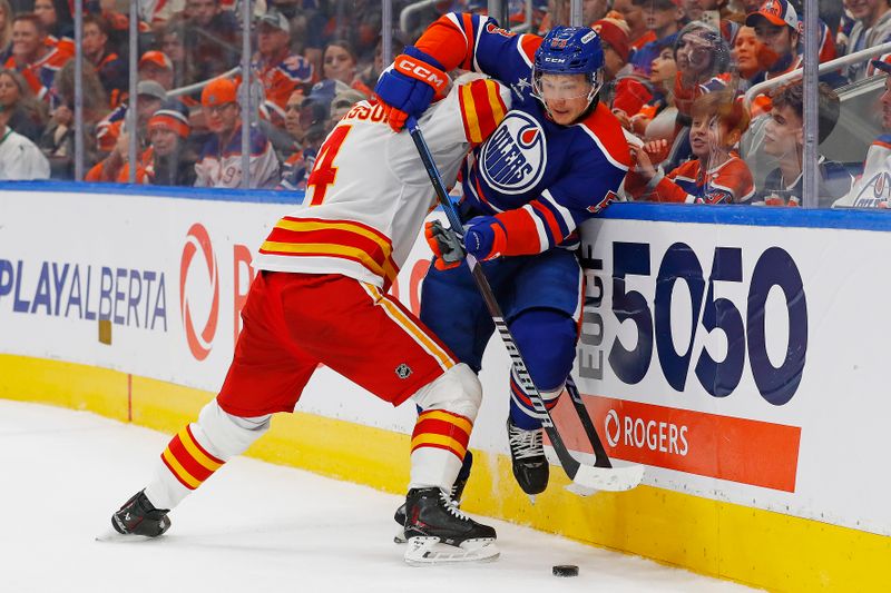 Oct 13, 2024; Edmonton, Alberta, CAN; Calgary Flames defensemen Rasmus Andersson (4) checks Edmonton Oilers forward Jeff Skinner (53) during the third period at Rogers Place. Mandatory Credit: Perry Nelson-Imagn Images