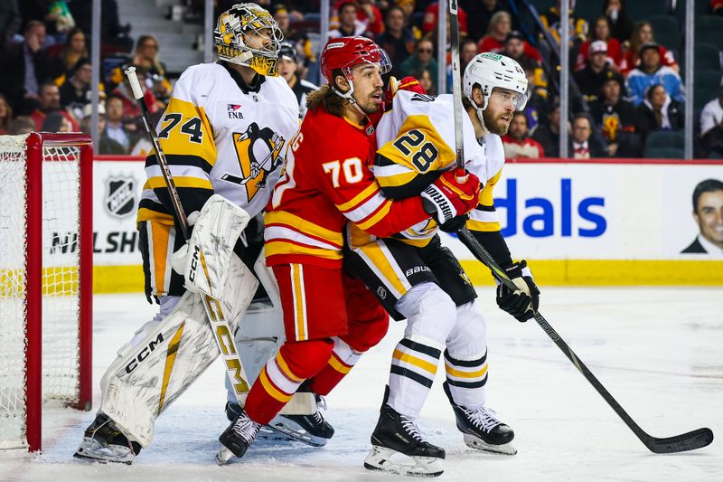 Jan 21, 2026; Calgary, Alberta, CAN; Calgary Flames left wing Ryan Lomberg (70) and Pittsburgh Penguins defenseman Parker Wotherspoon (28) fight for position in front of Pittsburgh Penguins goaltender Stuart Skinner (74) during the second period at Scotiabank Saddledome. Mandatory Credit: Sergei Belski-Imagn Images