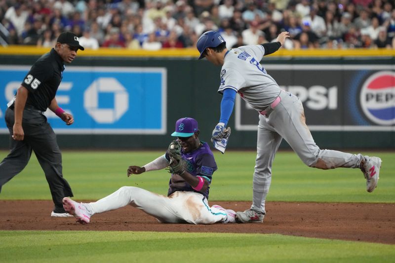 May 11, 2025; Phoenix, Arizona, USA; Arizona Diamondbacks shortstop Geraldo Perdomo (2) tags out Los Angeles Dodgers Shohei Ohtani (17) while trying to steal the base in the sixth inning at Chase Field. Mandatory Credit: Rick Scuteri-Imagn Images