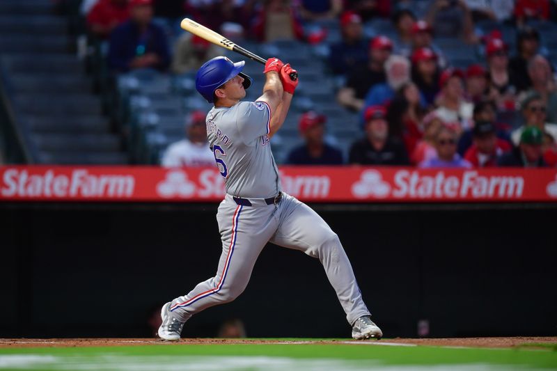 Sep 27, 2024; Anaheim, California, USA; Texas Rangers center fielder Wyatt Langford (36) hits a two run home run against the Los Angeles Angels during the first inning at Angel Stadium. Mandatory Credit: Gary A. Vasquez-Imagn Images