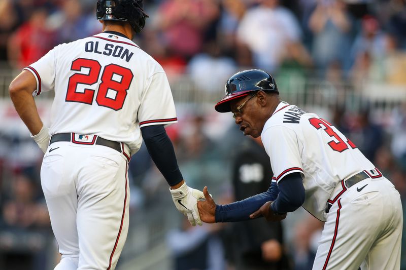 Apr 11, 2023; Atlanta, Georgia, USA; Atlanta Braves first baseman Matt Olson (28) celebrates after a home run with third base coach Ron Washington (37) against the Cincinnati Reds in the first inning at Truist Park. Mandatory Credit: Brett Davis-USA TODAY Sports
