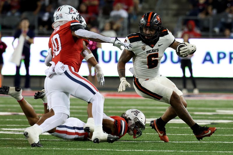 Oct 28, 2023; Tucson, Arizona, USA; Oregon State Beavers running back Damien Martinez #6 runs the ball against Arizona Wildcats linebacker Justin Flowe #10 during the second half at Arizona Stadium. Mandatory Credit: Zachary BonDurant-USA TODAY Sports