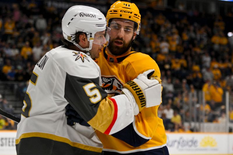 Mar 21, 2026; Nashville, Tennessee, USA;  Nashville Predators defenseman Nicolas Hague (41) and Vegas Golden Knights defenseman Jeremy Lauzon (5) shove each other during the third period at Bridgestone Arena. Mandatory Credit: Steve Roberts-Imagn Images