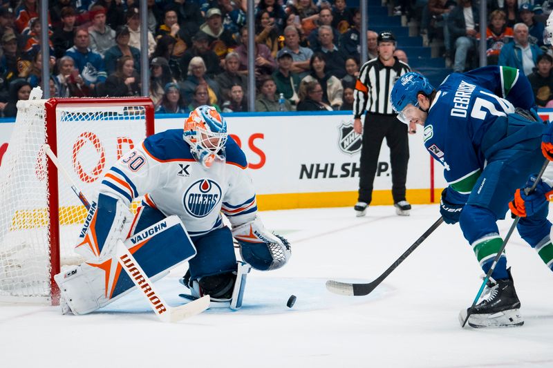 Oct 3, 2025; Vancouver, British Columbia, CAN; Edmonton Oilers goalie Calvin Pickard (30) makes a save on Vancouver Canucks forward Jake DeBrusk (74) in the third period at Rogers Arena. Mandatory Credit: Bob Frid-Imagn Images