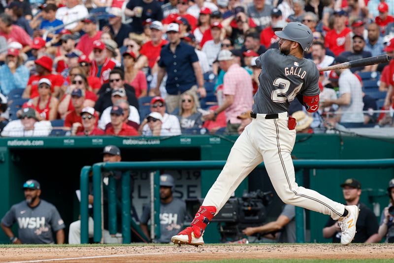 May 25, 2024; Washington, District of Columbia, USA; Washington Nationals first baseman Joey Gallo (24) hits an RBI single against the Seattle Mariners during the seventh inning at Nationals Park. Mandatory Credit: Geoff Burke-USA TODAY Sports