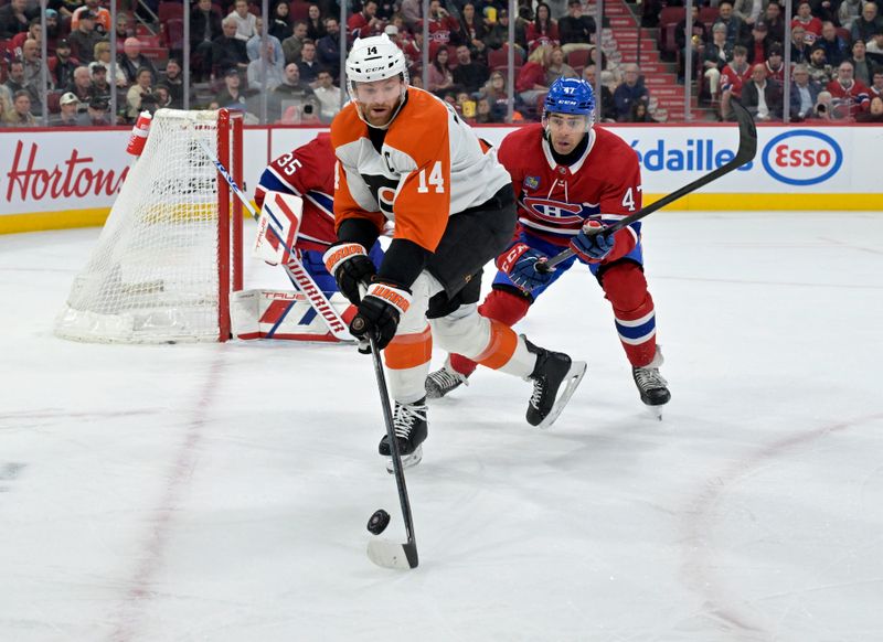 Apr 9, 2024; Montreal, Quebec, CAN; Philadelphia Flyers forward Sean Couturier (14) plays the puck and Montreal Canadiens defenseman Jayden Struble (47) defends during the first period at the Bell Centre. Mandatory Credit: Eric Bolte-USA TODAY Sports