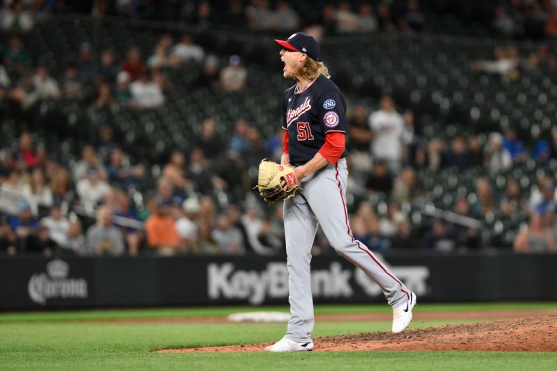 Jun 27, 2023; Seattle, Washington, USA; Washington Nationals relief pitcher Jordan Weems (51) reacts to the game-winning out to defeat the Seattle Mariners during the eleventh inning at T-Mobile Park. Mandatory Credit: Steven Bisig-USA TODAY Sports