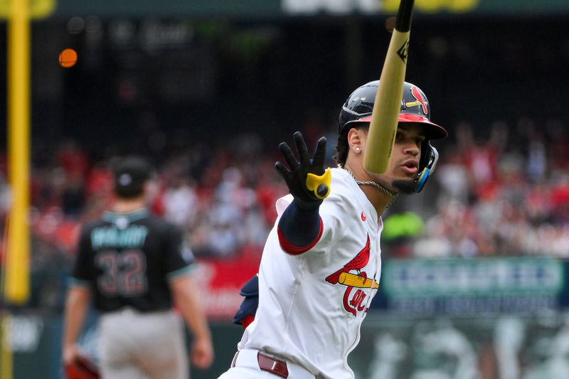 May 25, 2025; St. Louis, Missouri, USA;  St. Louis Cardinals shortstop Masyn Winn (0) flips his bat after hitting a solo home run off of Arizona Diamondbacks starting pitcher Brandon Pfaadt (32) during the third inning at Busch Stadium. Mandatory Credit: Jeff Curry-Imagn Images