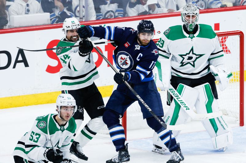 May 7, 2025; Winnipeg, Manitoba, CAN; Dallas Stars defenseman Cody Ceci (44) jostles for position with Winnipeg Jets forward Adam Lowry (17) in front of Dallas Stars goalie Jake Oettinger (29) during the third period in game one of the second round of the 2025 Stanley Cup Playoffs at Canada Life Centre. Mandatory Credit: Terrence Lee-Imagn Images