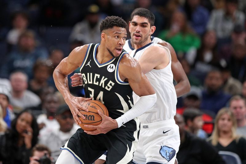 MEMPHIS, TENNESSEE - FEBRUARY 15: Giannis Antetokounmpo #34 of the Milwaukee Bucks handles the ball against Santi Aldama #7 of the Memphis Grizzlies during the second half at FedExForum on February 15, 2024 in Memphis, Tennessee.  NOTE TO USER: User expressly acknowledges and agrees that, by downloading and or using this photograph, User is consenting to the terms and conditions of the Getty Images License Agreement. (Photo by Justin Ford/Getty Images)