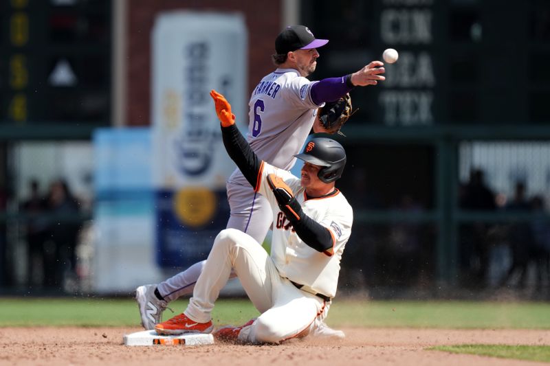 May 3, 2025; San Francisco, California, USA; Colorado Rockies shortstop Kyle Farmer (6) throws the ball to first base to complete a double play after forcing out San Francisco Giants third baseman Matt Chapman (front) during the eighth inning at Oracle Park. Mandatory Credit: Darren Yamashita-Imagn Images