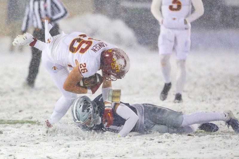 Nov 25, 2023; Manhattan, Kansas, USA; Iowa State Cyclones running back Carson Hansen (26) is tackled by Kansas State Wildcats cornerback Keenan Garber (1) during the second quarter at Bill Snyder Family Football Stadium. Mandatory Credit: Scott Sewell-USA TODAY Sports