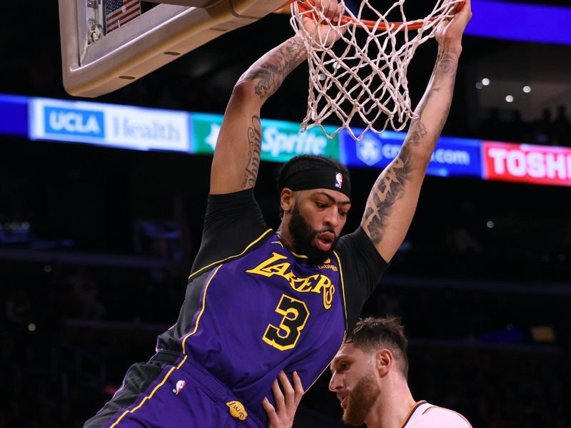 LOS ANGELES, CALIFORNIA - JANUARY 11: Anthony Davis #3 of the Los Angeles Lakers reacts to his dunk in front of Jusuf Nurkic #20 of the Phoenix Suns during the first half at Crypto.com Arena on January 11, 2024 in Los Angeles, California. User is consenting to the terms and conditions of the Getty Images License Agreement.  (Photo by Harry How/Getty Images)