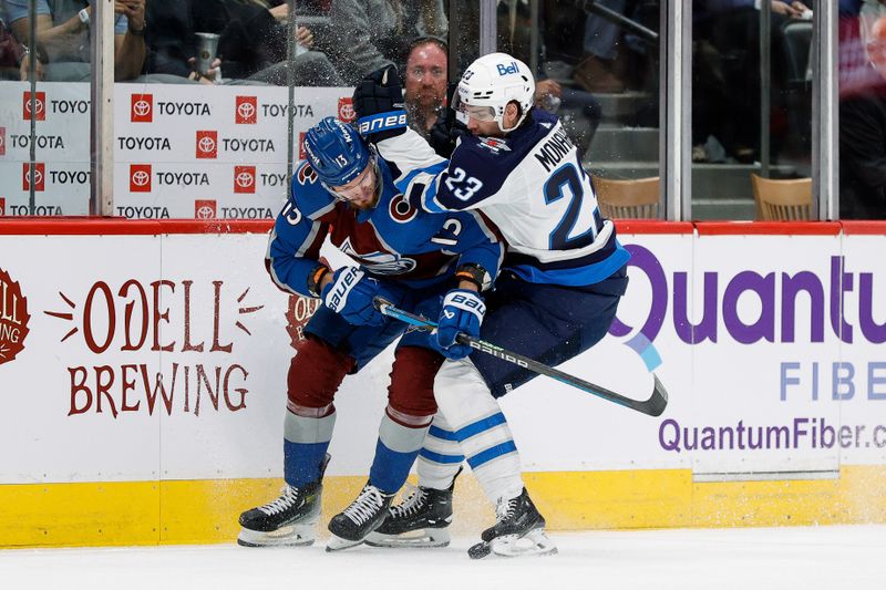 Apr 26, 2024; Denver, Colorado, USA; Colorado Avalanche right wing Valeri Nichushkin (13) and Winnipeg Jets center Sean Monahan (23) battle for the puck in the first period in game three of the first round of the 2024 Stanley Cup Playoffs at Ball Arena. Mandatory Credit: Isaiah J. Downing-USA TODAY Sports