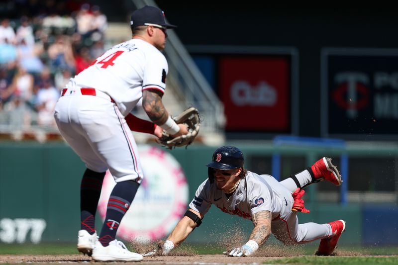 May 5, 2024; Minneapolis, Minnesota, USA; Boston Red Sox Jarren Duran (16) slides into third base for a triple as Minnesota Twins third baseman Jose Miranda (64) fields the ball during the eighth inning at Target Field. Mandatory Credit: Matt Krohn-USA TODAY Sports