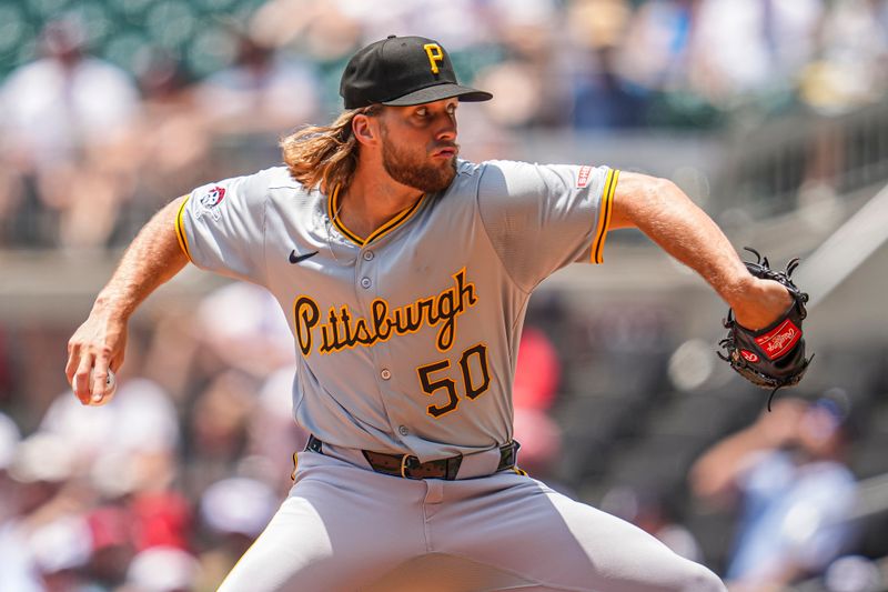 Jun 30, 2024; Cumberland, Georgia, USA; Pittsburgh Pirates relief pitcher Carmen Mlodzinski (50) pitches against the Atlanta Braves during the eighth inning at Truist Park. Mandatory Credit: Dale Zanine-USA TODAY Sports