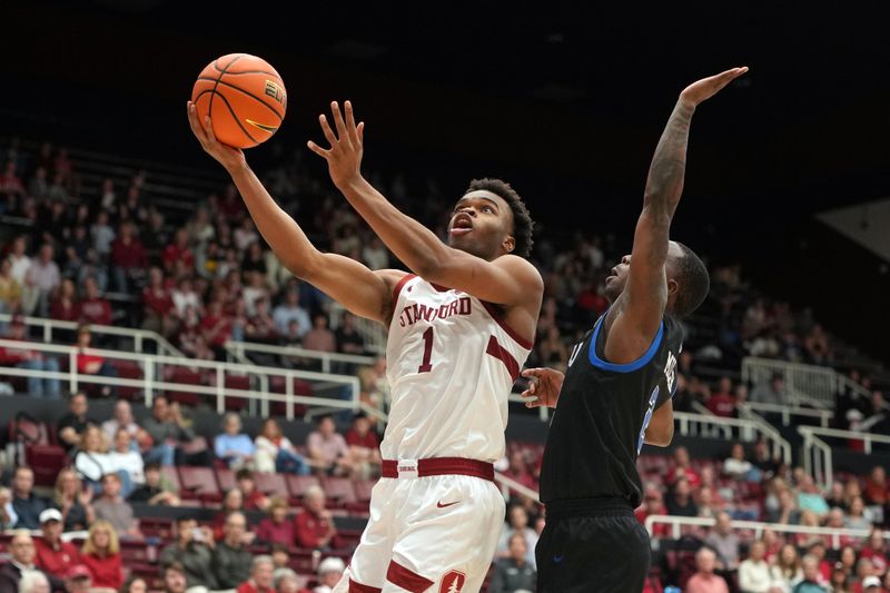 Feb 28, 2026; Stanford, California, USA; Stanford Cardinal guard Ebuka Okorie (1) shoots against Southern Methodist University Mustangs guard Boopie Miller (right) during the first half at Maples Pavilion. Mandatory Credit: Darren Yamashita-Imagn Images