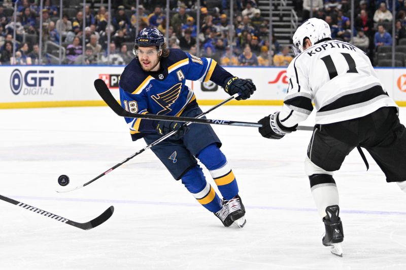 Jan 28, 2024; St. Louis, Missouri, USA; St. Louis Blues center Robert Thomas (18) controls the puck from Los Angeles Kings center Anze Kopitar (11) during the second period at Enterprise Center. Mandatory Credit: Jeff Le-USA TODAY Sports