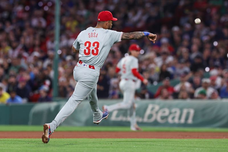 Jun 11, 2024; Boston, Massachusetts, USA; Philadelphia Phillies shortstop Edmundo Sosa (33) throws to first during the seventh inning against the Boston Red Sox at Fenway Park. Mandatory Credit: Paul Rutherford-USA TODAY Sports