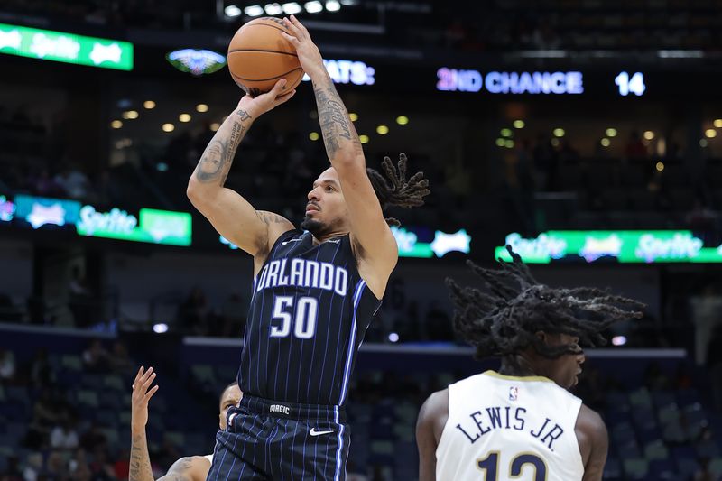 NEW ORLEANS, LOUISIANA - OCTOBER 10: Cole Anthony #50 of the Orlando Magic shoots against Kira Lewis Jr. #13 of the New Orleans Pelicans during the second half of a preseason game at the Smoothie King Center on October 10, 2023 in New Orleans, Louisiana. NOTE TO USER: User expressly acknowledges and agrees that, by downloading and or using this Photograph, user is consenting to the terms and conditions of the Getty Images License Agreement. (Photo by Jonathan Bachman/Getty Images)