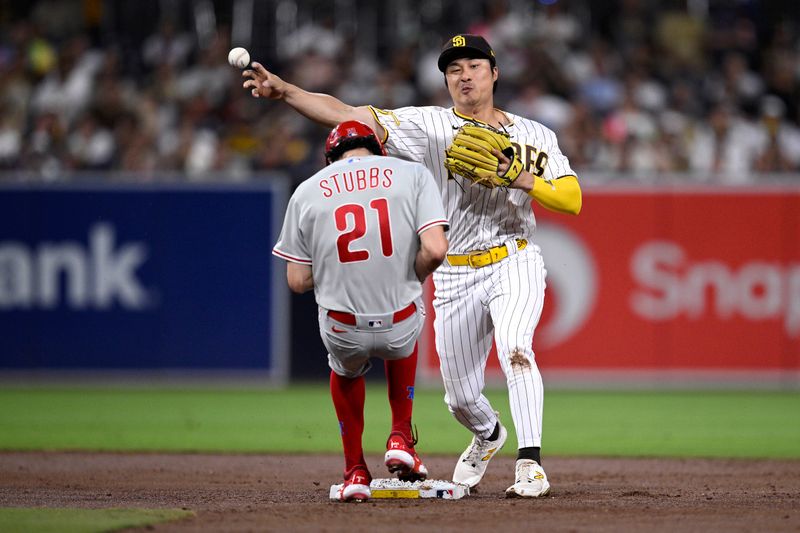 Sep 5, 2023; San Diego, California, USA; San Diego Padres third baseman Ha-seong Kim (7) throws to first base after forcing out Philadelphia Phillies catcher Garrett Stubbs (21) at second base to complete a double play during the third inning at Petco Park. Mandatory Credit: Orlando Ramirez-USA TODAY Sports