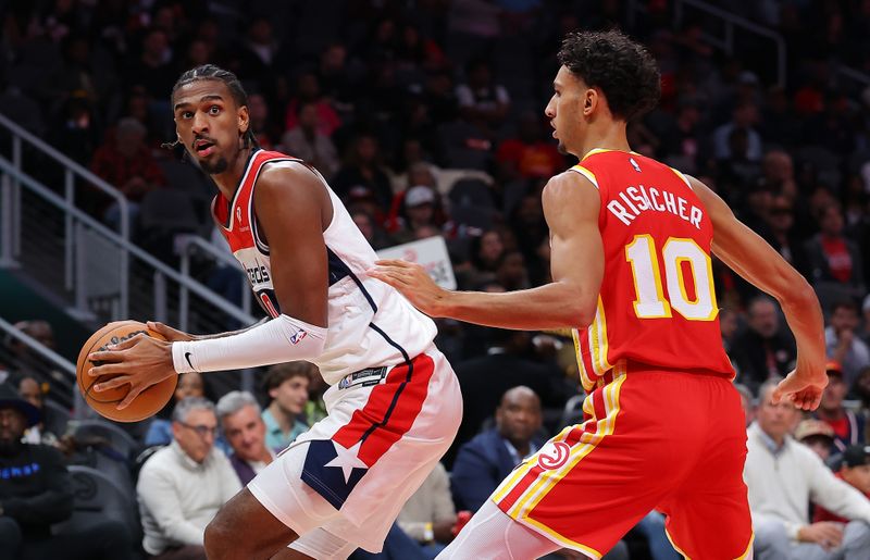 ATLANTA, GEORGIA - OCTOBER 28:  Alexandre Sarr #20 of the Washington Wizards turns to shoot against Zaccharie Risacher #10 of the Atlanta Hawks during the second quarter at State Farm Arena on October 28, 2024 in Atlanta, Georgia.  NOTE TO USER: User expressly acknowledges and agrees that, by downloading and/or using this photograph, user is consenting to the terms and conditions of the Getty Images License Agreement.  (Photo by Kevin C. Cox/Getty Images)