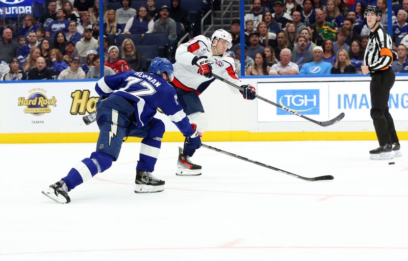 Nov 27, 2024; Tampa, Florida, USA; Washington Capitals center Aliaksei Protas (21) shoots and scores past Tampa Bay Lightning defenseman Victor Hedman (77) during the second period at Amalie Arena. Mandatory Credit: Kim Klement Neitzel-Imagn Images