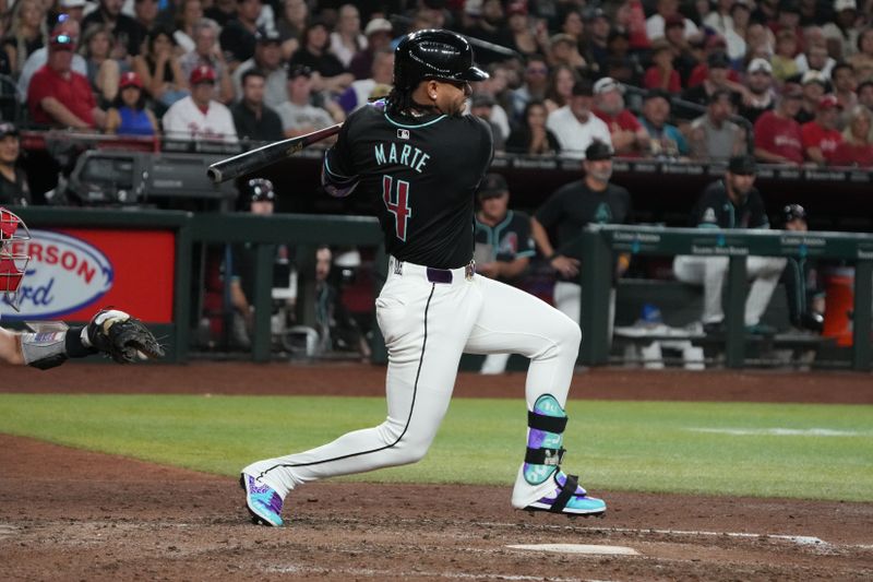 Aug 9, 2024; Phoenix, Arizona, USA; Arizona Diamondbacks second base Ketel Marte (4) hits a single against the Philadelphia Phillies in the eighth inning at Chase Field. Mandatory Credit: Rick Scuteri-USA TODAY Sports