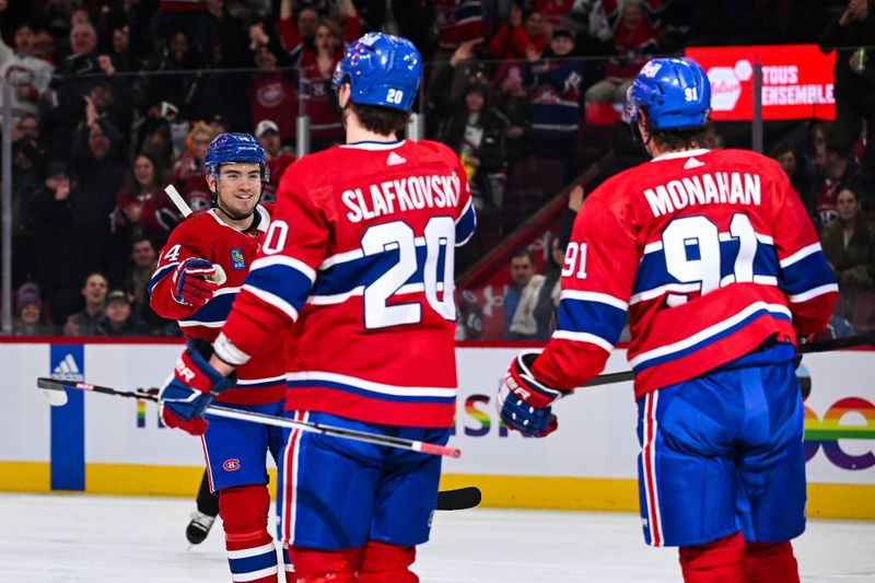 Jan 15, 2024; Montreal, Quebec, CAN; Montreal Canadiens center Nick Suzuki (14) skates towards left wing Juraj Slafkovsky (20) who scored a goal against the Colorado Avalanche during the first period at Bell Centre. Mandatory Credit: David Kirouac-USA TODAY Sports