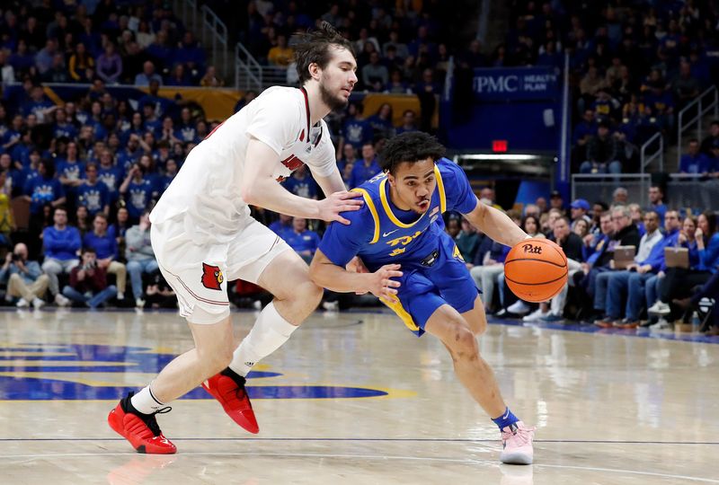 Feb 17, 2024; Pittsburgh, Pennsylvania, USA;  Pittsburgh Panthers guard Ishmael Leggett (5) drives to the basket against Louisville Cardinals forward Danilo Jovanovich (13) during the second half at the Petersen Events Center. Pittsburgh won 86-59. Mandatory Credit: Charles LeClaire-USA TODAY Sports