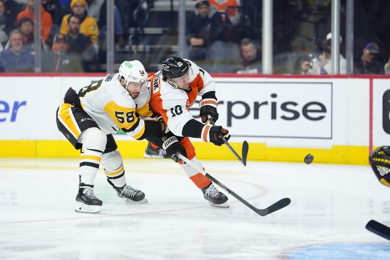 Dec 1, 2025; Philadelphia, Pennsylvania, USA; Philadelphia Flyers right wing Bobby Brink (10) shoots against Pittsburgh Penguins defenseman Kris Letang (58) in the first period at Xfinity Mobile Arena. Mandatory Credit: Kyle Ross-Imagn Images