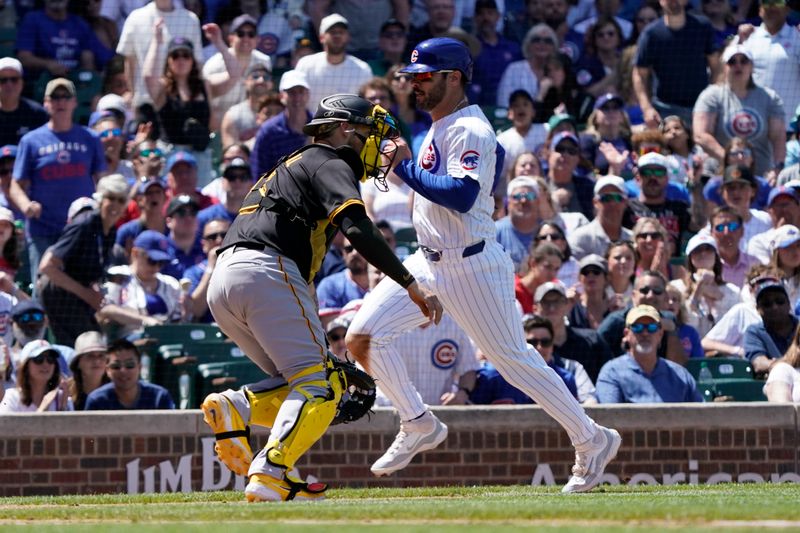 May 19, 2024; Chicago, Illinois, USA; Chicago Cubs shortstop Miles Mastrobuoni (20) scores as Pittsburgh Pirates catcher Yasmani Grandal (6) takes a late throw during the third inning at Wrigley Field. Mandatory Credit: David Banks-USA TODAY Sports