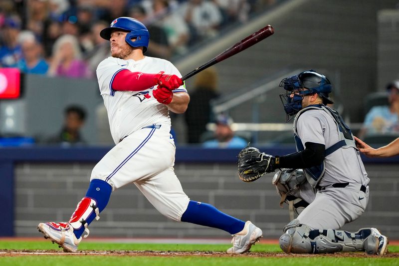 Jun 29, 2024; Toronto, Ontario, CAN; Toronto Blue Jays catcher Alejandro Kirk (30) hits a single against the New York Yankees during the sixth inning at Rogers Centre. Mandatory Credit: Kevin Sousa-USA TODAY Sports