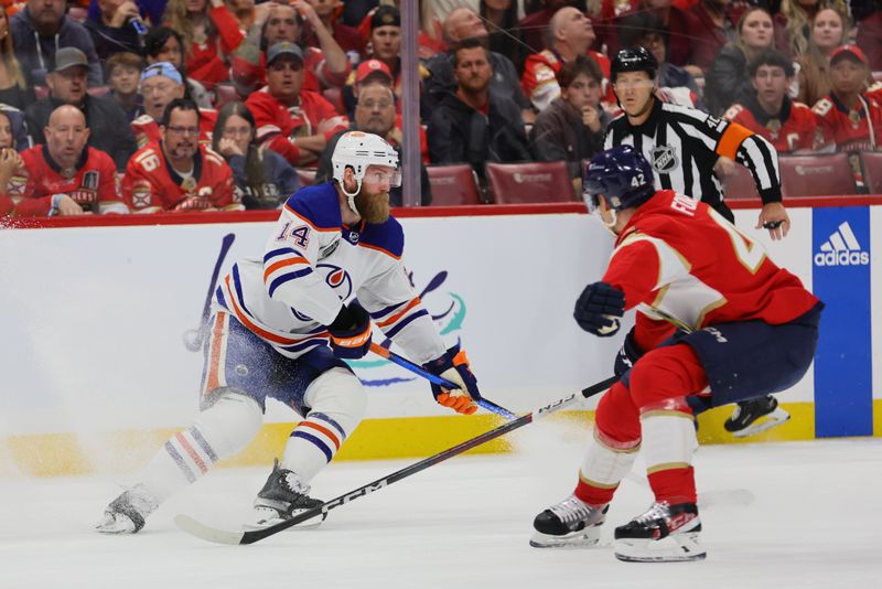 Jun 8, 2024; Sunrise, Florida, USA; Edmonton Oilers forward Connor McDavid (97) controls the puck against Florida Panthers defenseman Aaron Ekblad (5) during the first period in game one of the 2024 Stanley Cup Final at Amerant Bank Arena. Mandatory Credit: Sam Navarro-USA TODAY Sports