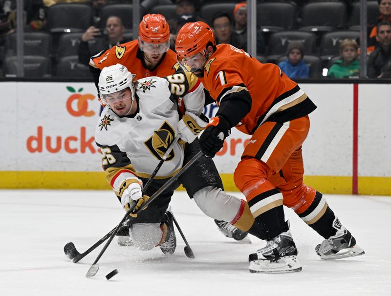 Dec 4, 2024; Anaheim, California, USA; Vegas Golden Knights right wing Alexander Holtz (26) shoots against Anaheim Ducks defenseman Radko Gudas (7) and defenseman Cam Fowler (4) during the first period at Honda Center. Mandatory Credit: Alex Gallardo-Imagn Images