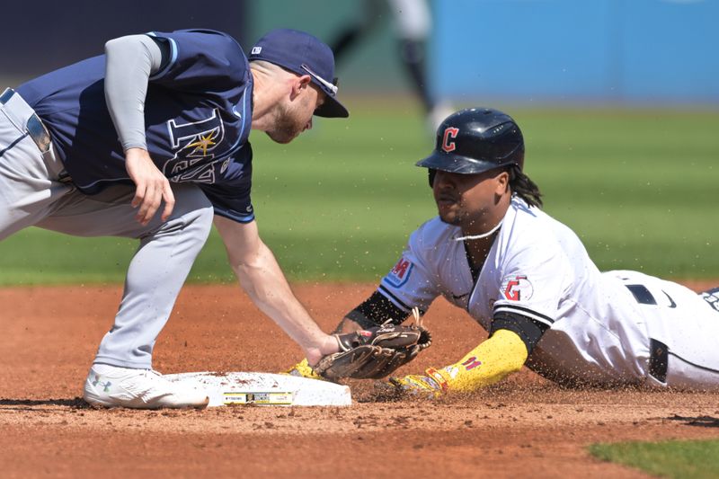 Sep 15, 2024; Cleveland, Ohio, USA; Cleveland Guardians designated hitter Jose Ramirez (11) slides into second with a double as Tampa Bay Rays second baseman Brandon Lowe (8) is late with the tag during the first inning at Progressive Field. Mandatory Credit: Ken Blaze-Imagn Images