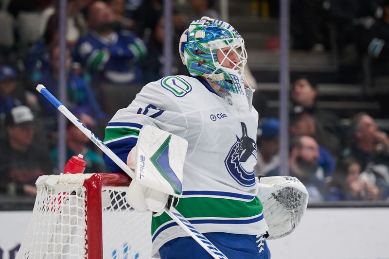 Nov 2, 2024; San Jose, California, USA; Vancouver Canucks goaltender Kevin Lankinen (32) waits for play to resume against the San Jose Sharks during the second period at SAP Center at San Jose. Mandatory Credit: Robert Edwards-Imagn Images