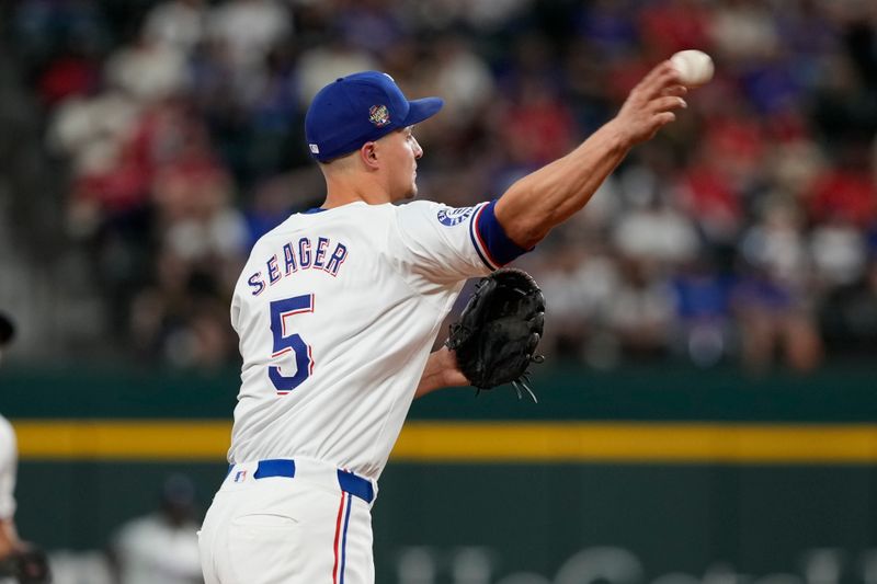 Apr 24, 2024; Arlington, Texas, USA; Texas Rangers shortstop Corey Seager (5) throws to first base forcing out Seattle Mariners catcher Seby Zavala (not shown) during the fourth inning at Globe Life Field. Mandatory Credit: Jim Cowsert-USA TODAY Sports