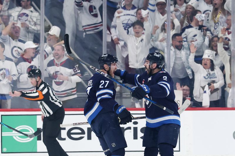 May 9, 2025; Winnipeg, Manitoba, CAN;Winnipeg Jets left wing Nikolaj Ehlers (27) celebrates his goal against the Dallas Stars with Winnipeg Jets defenseman Dylan DeMelo (2) in the first period in game two of the second round of the 2025 Stanley Cup Playoffs at Canada Life Centre. Mandatory Credit: James Carey Lauder-Imagn Images