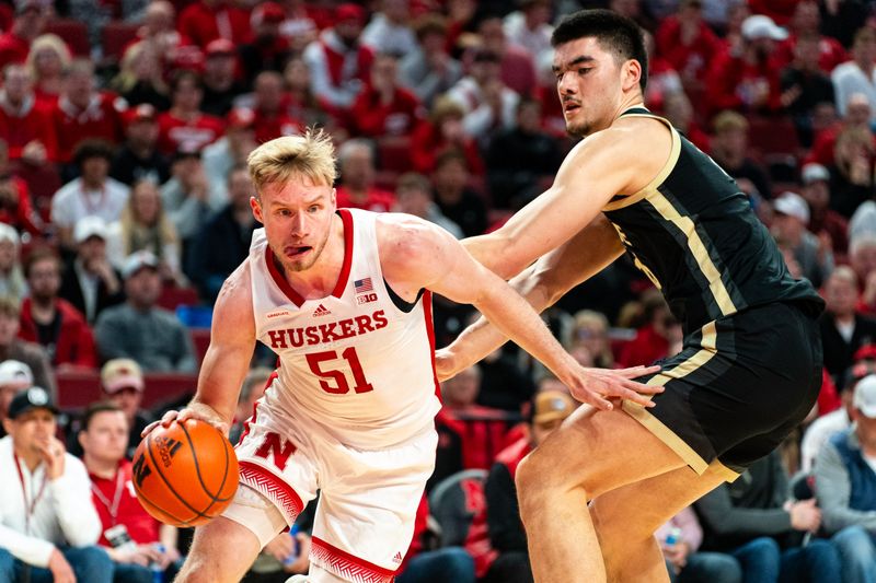 Jan 9, 2024; Lincoln, Nebraska, USA; Nebraska Cornhuskers forward Rienk Mast (51) drives against Purdue Boilermakers center Zach Edey (15) during the first half at Pinnacle Bank Arena. Mandatory Credit: Dylan Widger-USA TODAY Sports