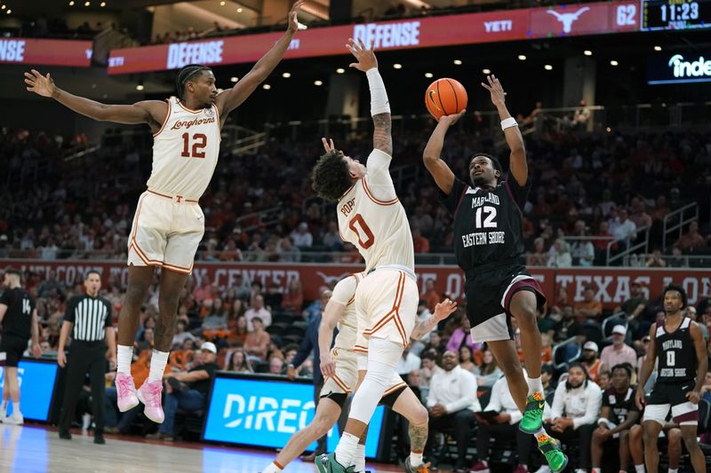 Dec 22, 2025; Austin, Texas, USA;Maryland Eastern Shore Hawks guard Justin Monden (12) shoots the ball against Texas Longhorns guard Jordan Pope (0) and guard Tramon Mark (12) during the second half at Moody Center. Mandatory Credit: Dustin Safranek-Imagn Images