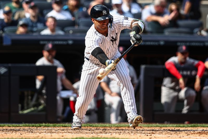 Sep 15, 2024; Bronx, New York, USA;  New York Yankees second baseman Gleyber Torres (25) attempts a bunt in the fourth inning against the Boston Red Sox at Yankee Stadium. Mandatory Credit: Wendell Cruz-Imagn Images