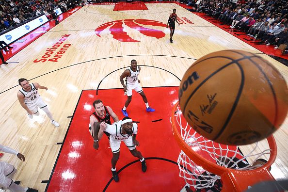 TORONTO, CANADA - NOVEMBER 15: Bobby Portis #9 of the Milwaukee Bucks boxes out Jakob Poeltl #19 of the Toronto Raptors as they watch the ball fall into the basket during the second half of their NBA game at Scotiabank Arena on November 15, 2023 in Toronto, Canada. NOTE TO USER: User expressly acknowledges and agrees that, by downloading and or using this photograph, User is consenting to the terms and conditions of the Getty Images License Agreement. (Photo by Cole Burston/Getty Images)