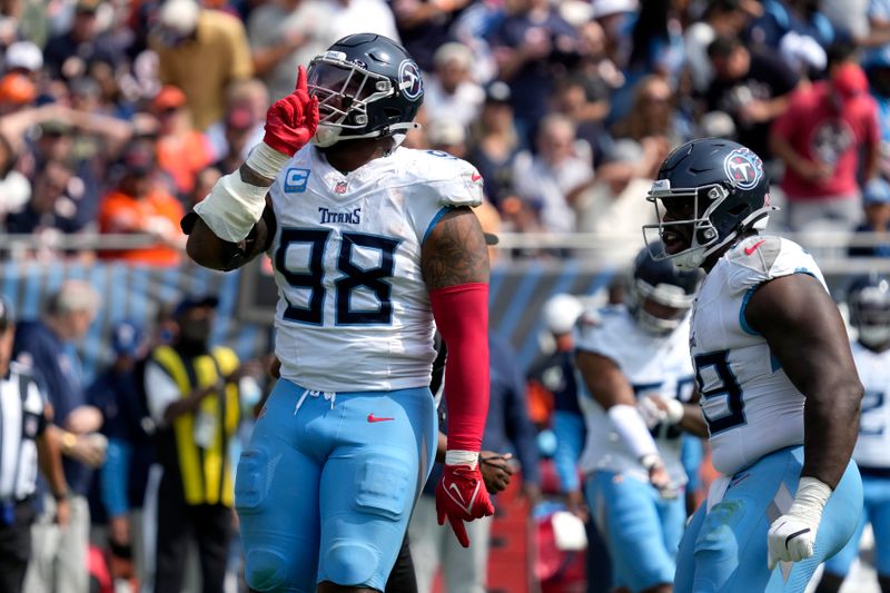 Tennessee Titans defensive tackle Jeffery Simmons gestures to the crowd after tackling Chicago Bears running back D'Andre Swift for a loss during the second half of an NFL football game Sunday, Sept. 8, 2024, in Chicago. (AP Photo/Nam Y. Huh)