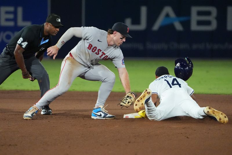 Sep 21, 2025; Tampa, Florida, USA; Tampa Bay Rays outfielder Chandler Simpson (14) steals second as Boston Red Sox shortstop Trevor Story (10) tries to make the tag during the fifth inning at George M. Steinbrenner Field. Mandatory Credit: Dave Nelson-Imagn Images
