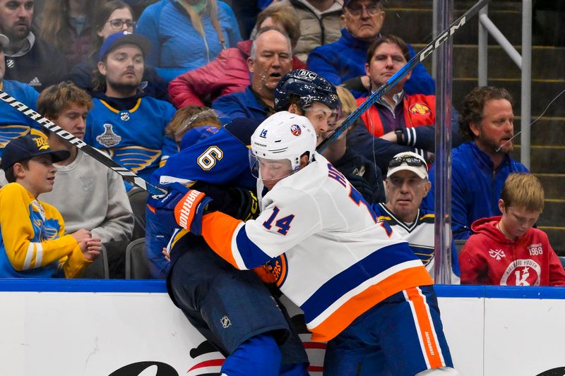 Oct 17, 2024; St. Louis, Missouri, USA;  New York Islanders center Bo Horvat (14) checks St. Louis Blues defenseman Philip Broberg (6) during the third period at Enterprise Center. Mandatory Credit: Jeff Curry-Imagn Images