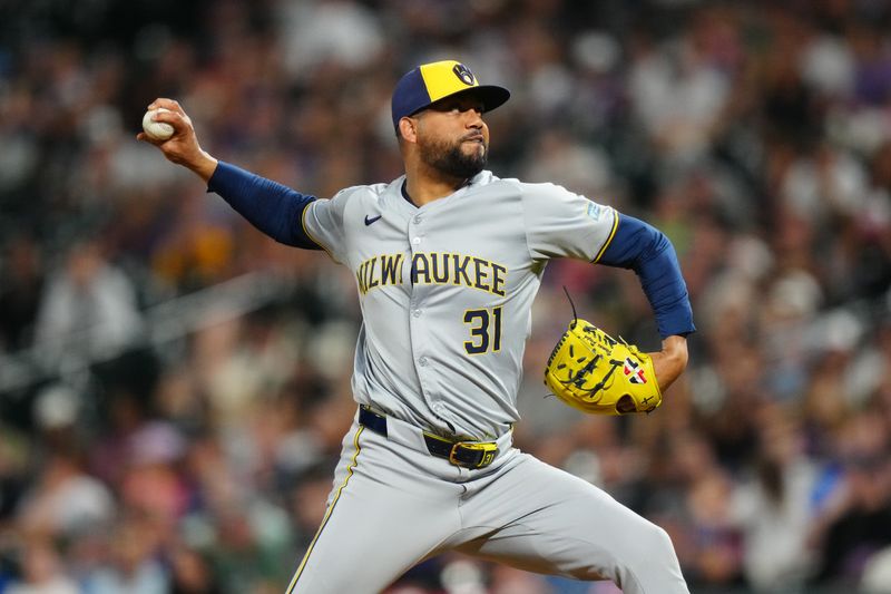 Jul 1, 2024; Denver, Colorado, USA; Milwaukee Brewers relief pitcher Joel Payamps (31) delivers a pitch in the tenth inning against the Colorado Rockies at Coors Field. Mandatory Credit: Ron Chenoy-USA TODAY Sports