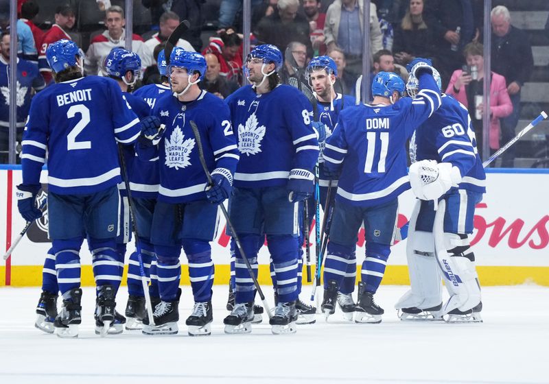 Nov 9, 2024; Toronto, Ontario, CAN; Toronto Maple Leafs center Max Domi (11) celebrates the win with goaltender Joseph Woll (60) against the Montreal Canadiens at the end of the third period at Scotiabank Arena. 
Mandatory Credit: Nick Turchiaro-Imagn Images