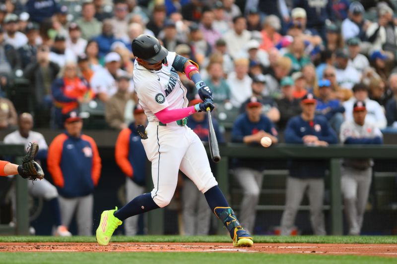 May 27, 2024; Seattle, Washington, USA; Seattle Mariners center fielder Julio Rodriguez (44) hits a single against the Houston Astros during the first inning at T-Mobile Park. Mandatory Credit: Steven Bisig-USA TODAY Sports