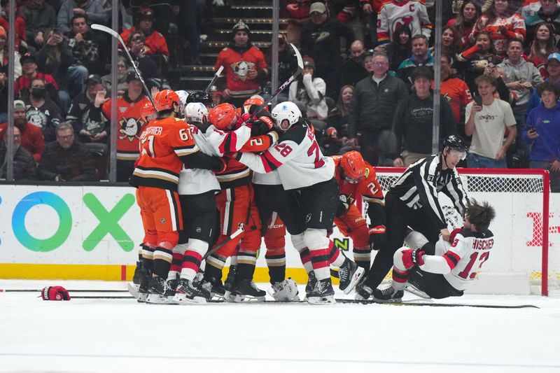 Dec 31, 2024; Anaheim, California, USA; Anaheim Ducks center Mason McTavish (23) and New Jersey Devils center Nico Hischier (13) fight in the third period at Honda Center. Mandatory Credit: Kirby Lee-Imagn Images